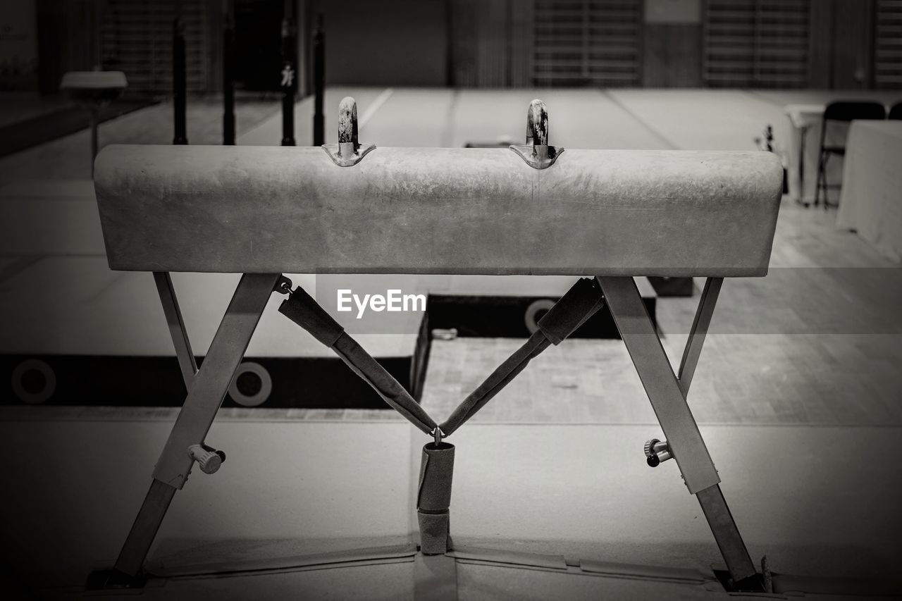 CLOSE-UP OF EMPTY SEATS ON TABLE IN OLD BUILDING