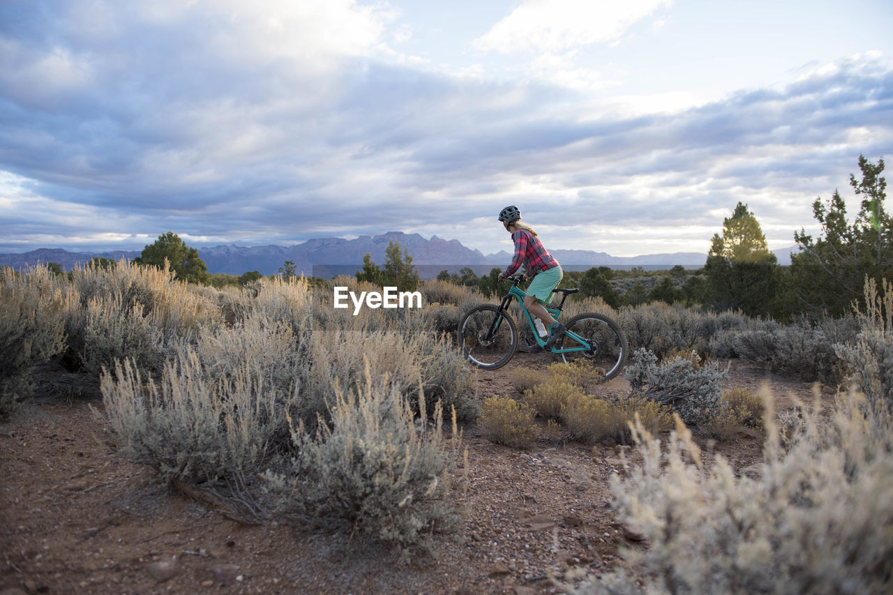 A woman riding her mountain bike on gooseberry mesa, utah