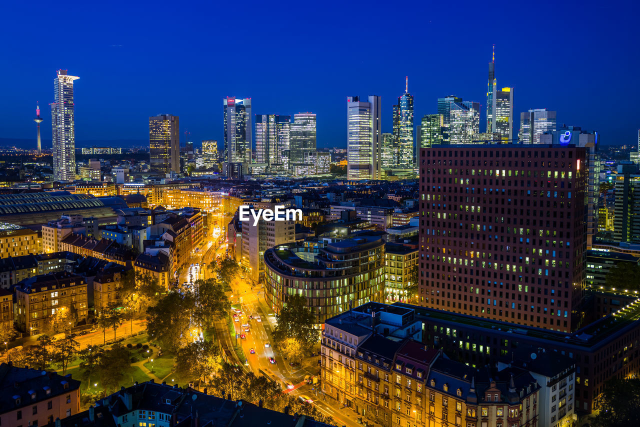 High angle view of illuminated buildings in city at dusk