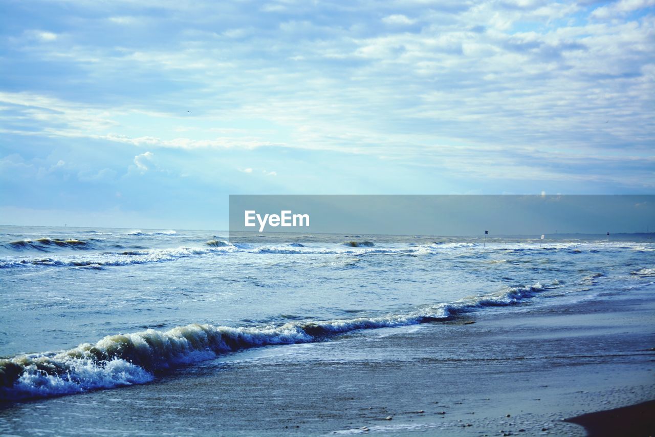 Scenic view of sea against cloudy sky