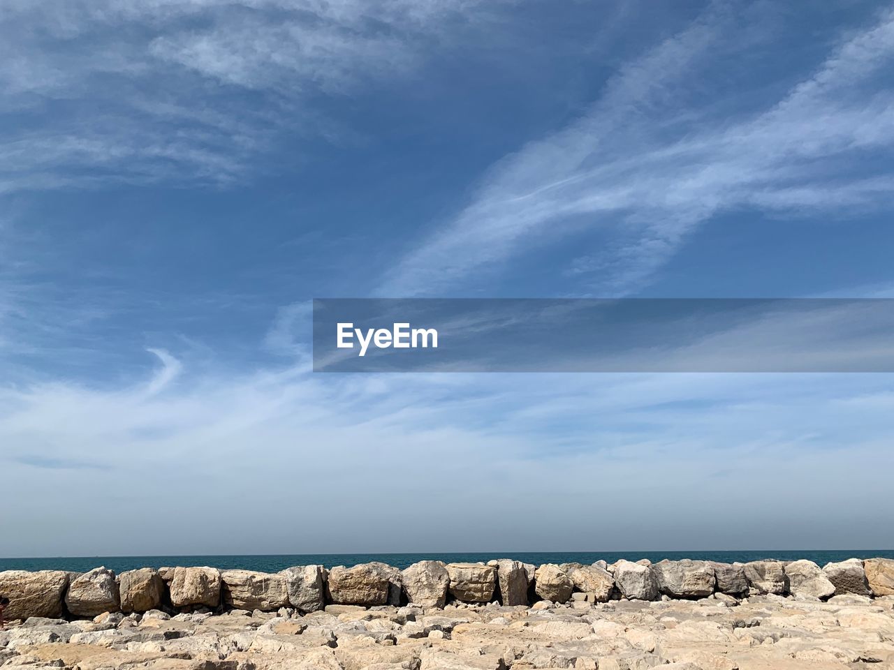 ROCKS ON SEA SHORE AGAINST SKY