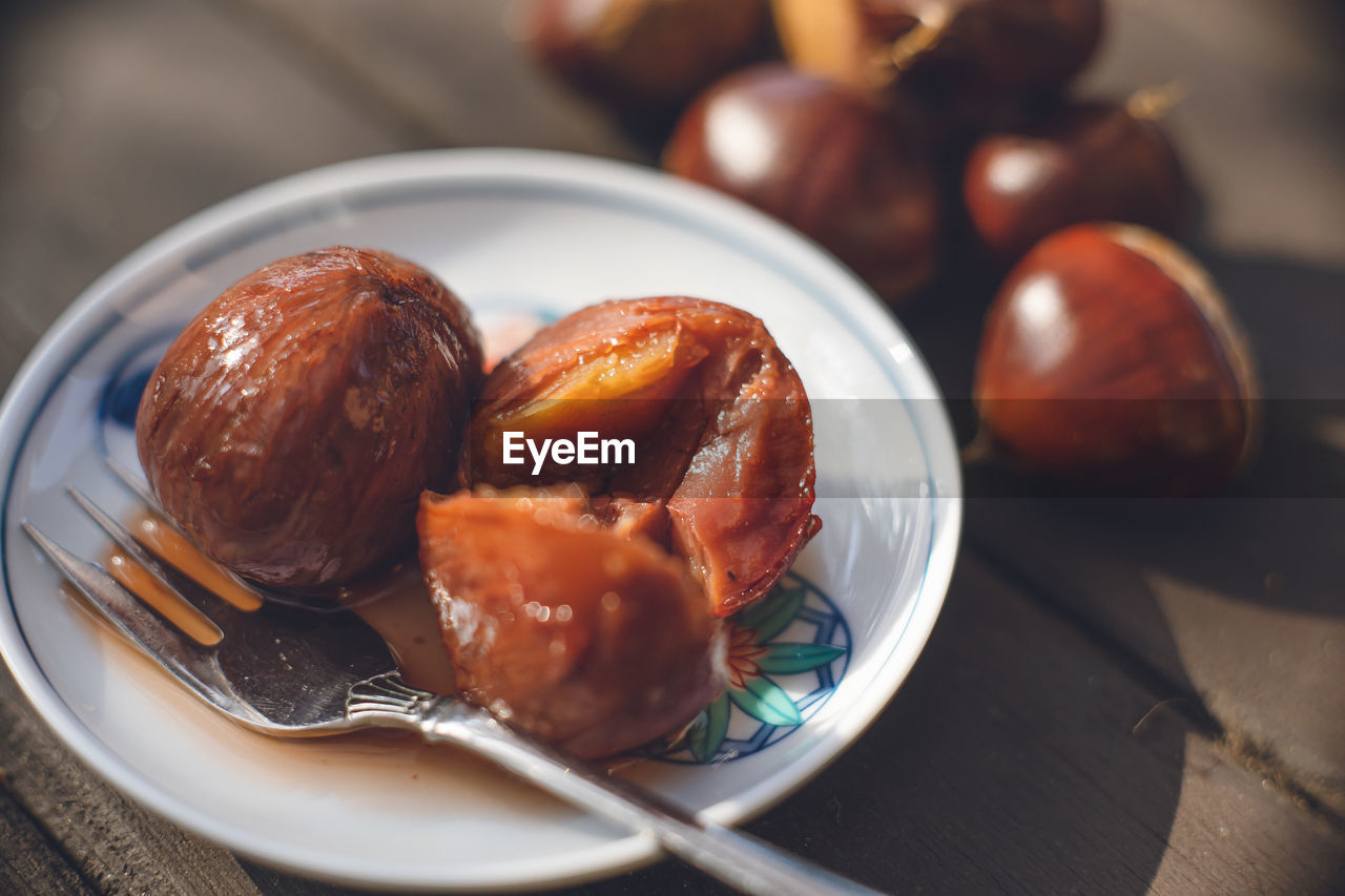 Handmade at home autumn taste on a small arita porcelain plate chestnuts simmered in astringent skin