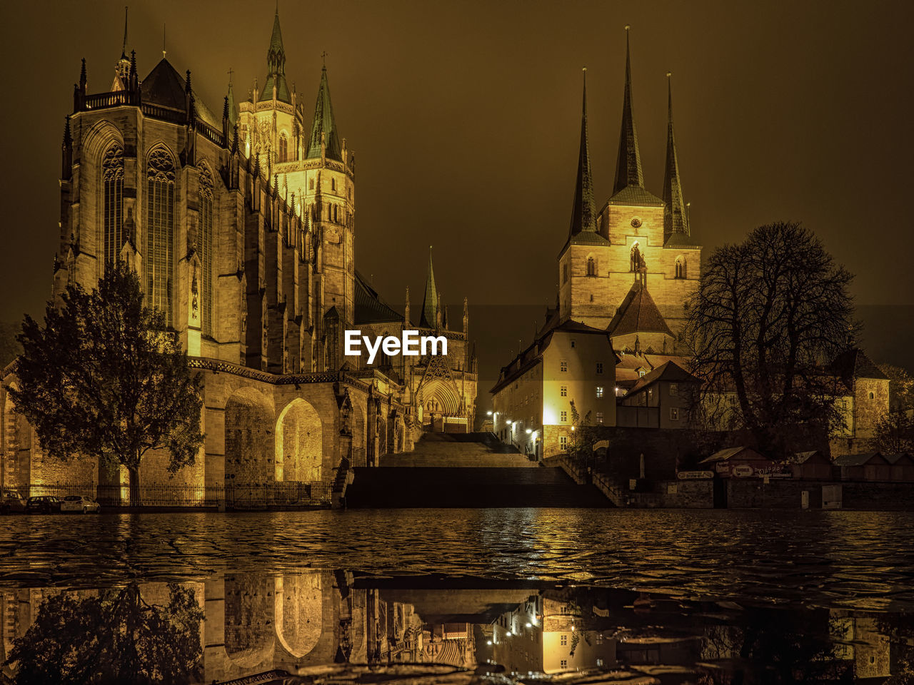 Illuminated church in city against sky at night