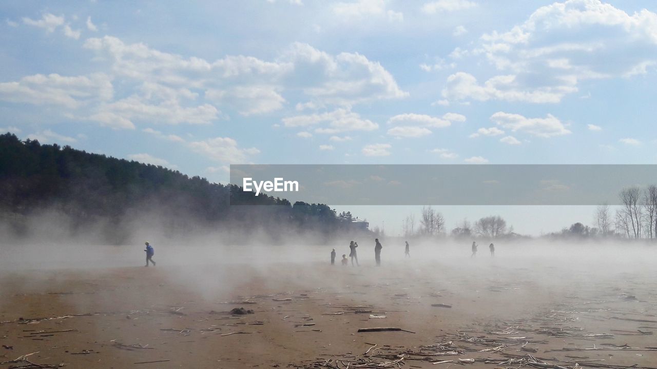 PEOPLE ON LANDSCAPE AGAINST SKY