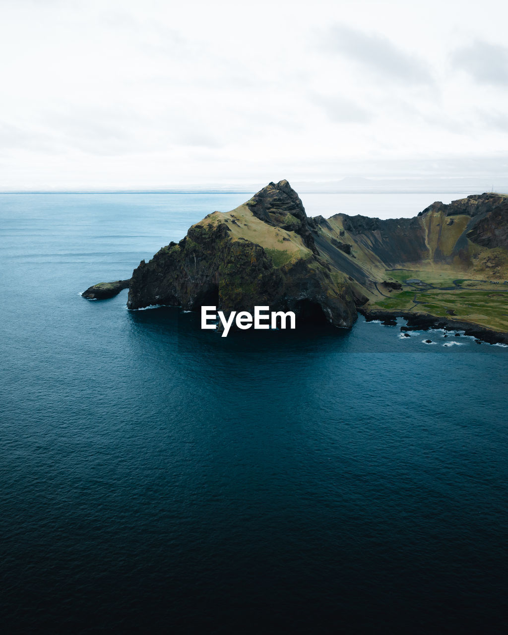 scenic view of sea and mountains against sky