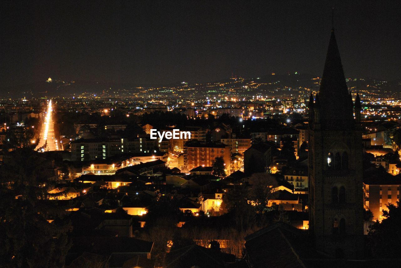 High angle view of city lit up at night