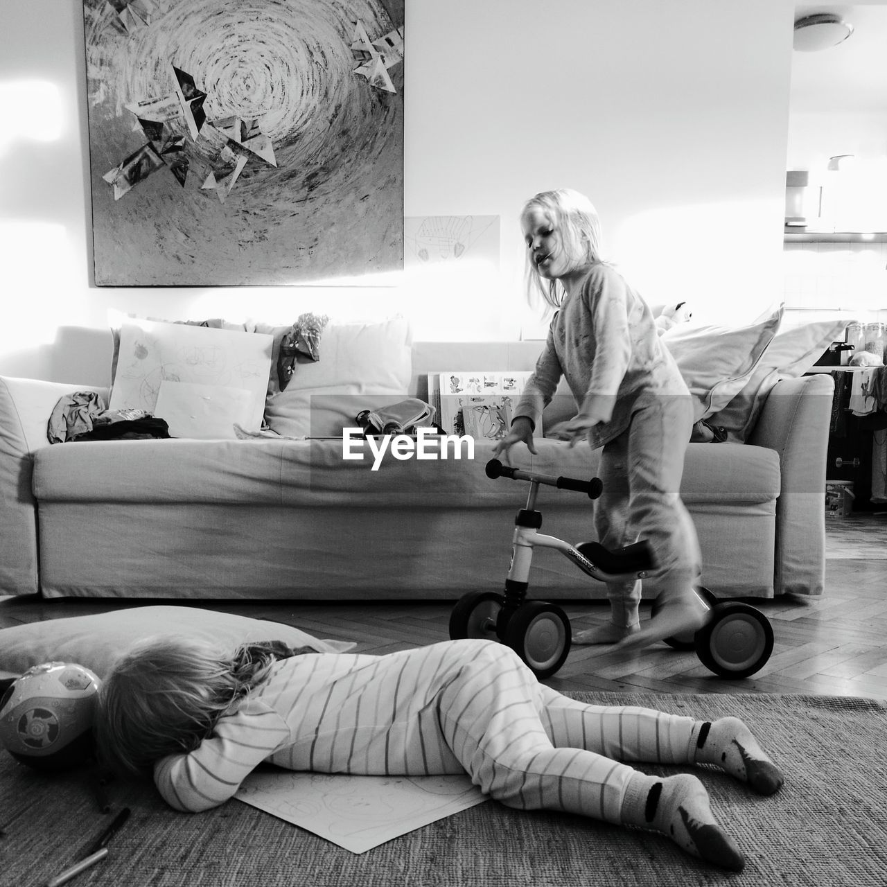 WOMAN LYING DOWN ON FLOOR AT HOME