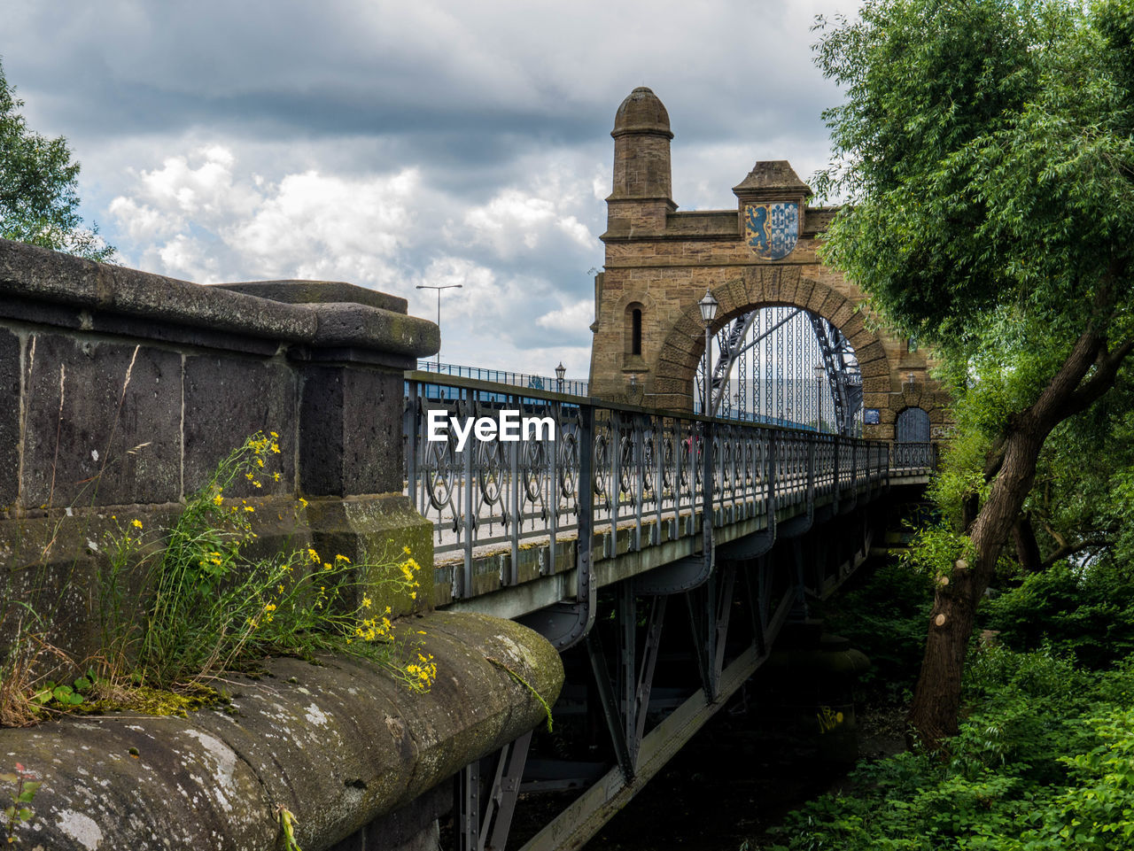 BRIDGE BY RIVER AGAINST SKY