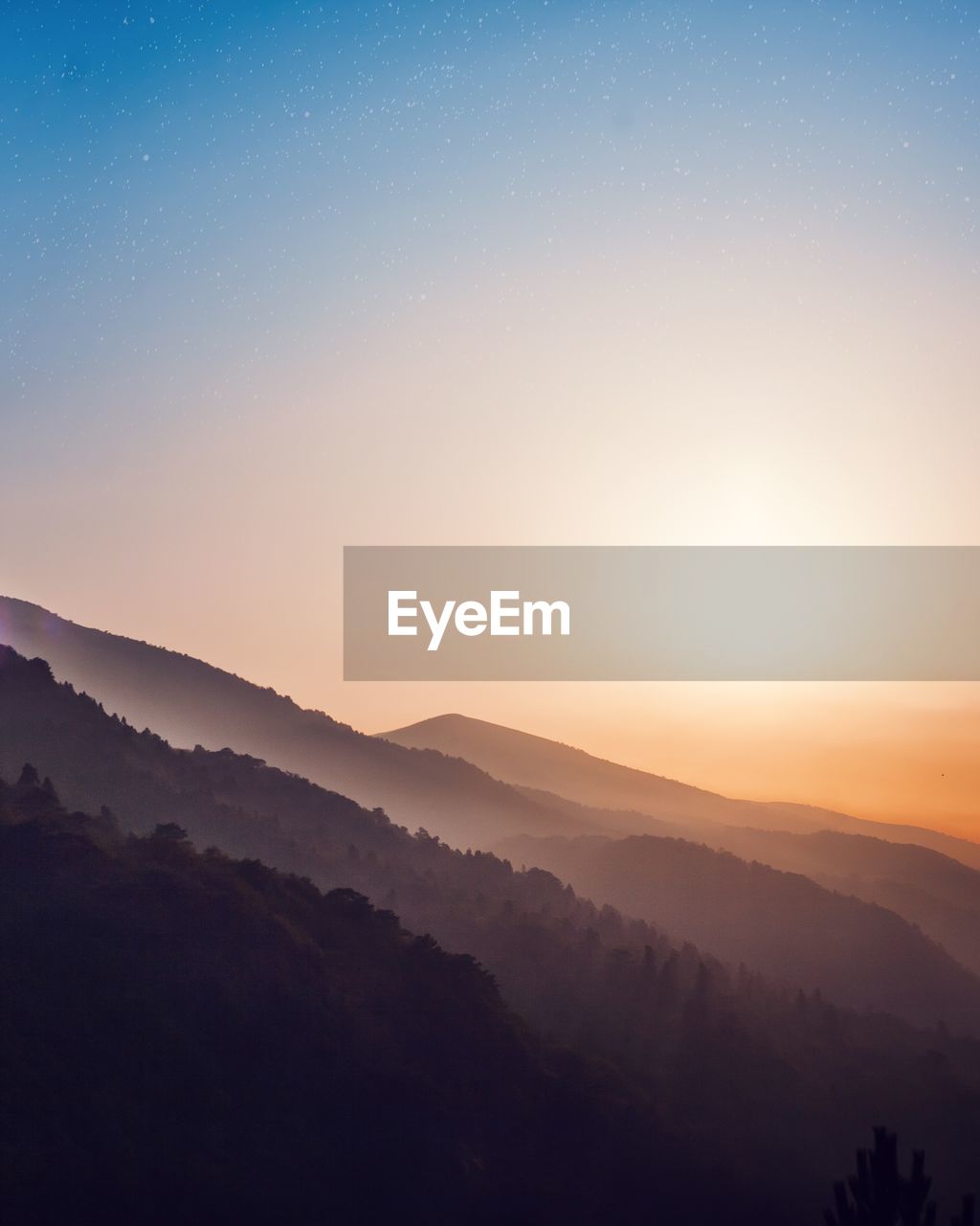 Scenic view of mountains against sky during sunset