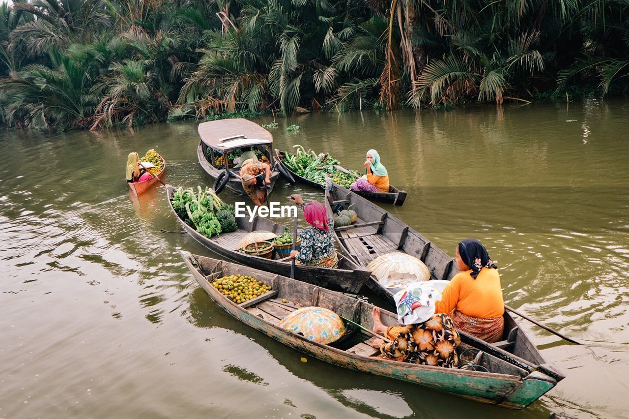 High angle view of people selling fruits and vegetables in boat