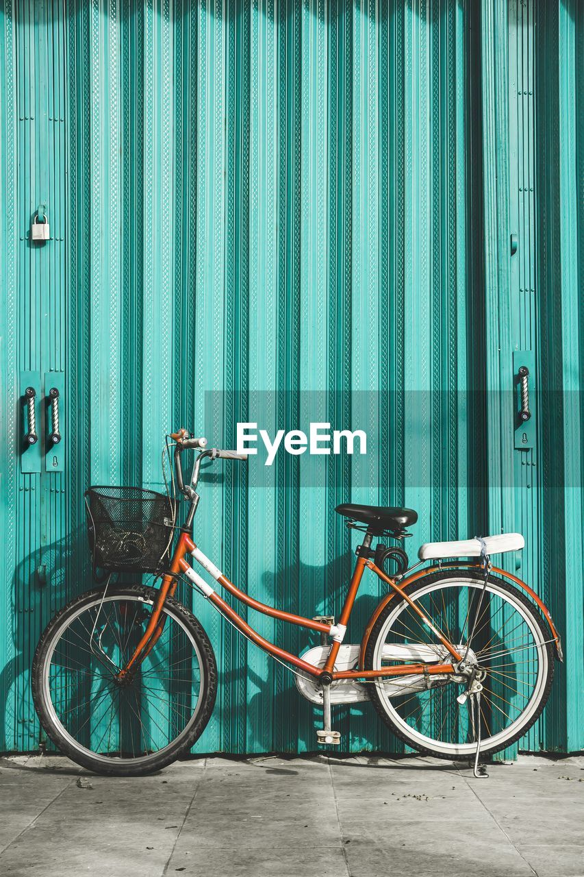 Bicycles in front of turqoise color steel rolling door