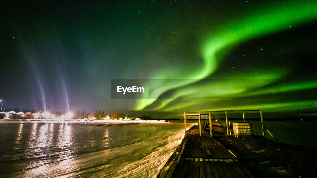 Panoramic view of illuminated landscape against sky at night