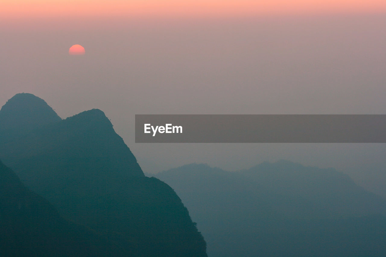 Scenic view of mountains against sky during sunset