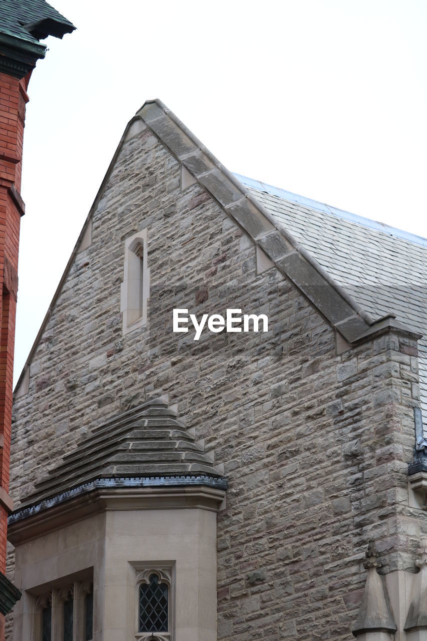 LOW ANGLE VIEW OF ROOF AGAINST CLEAR SKY