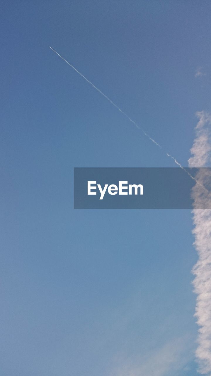 LOW ANGLE VIEW OF VAPOR TRAILS IN SKY