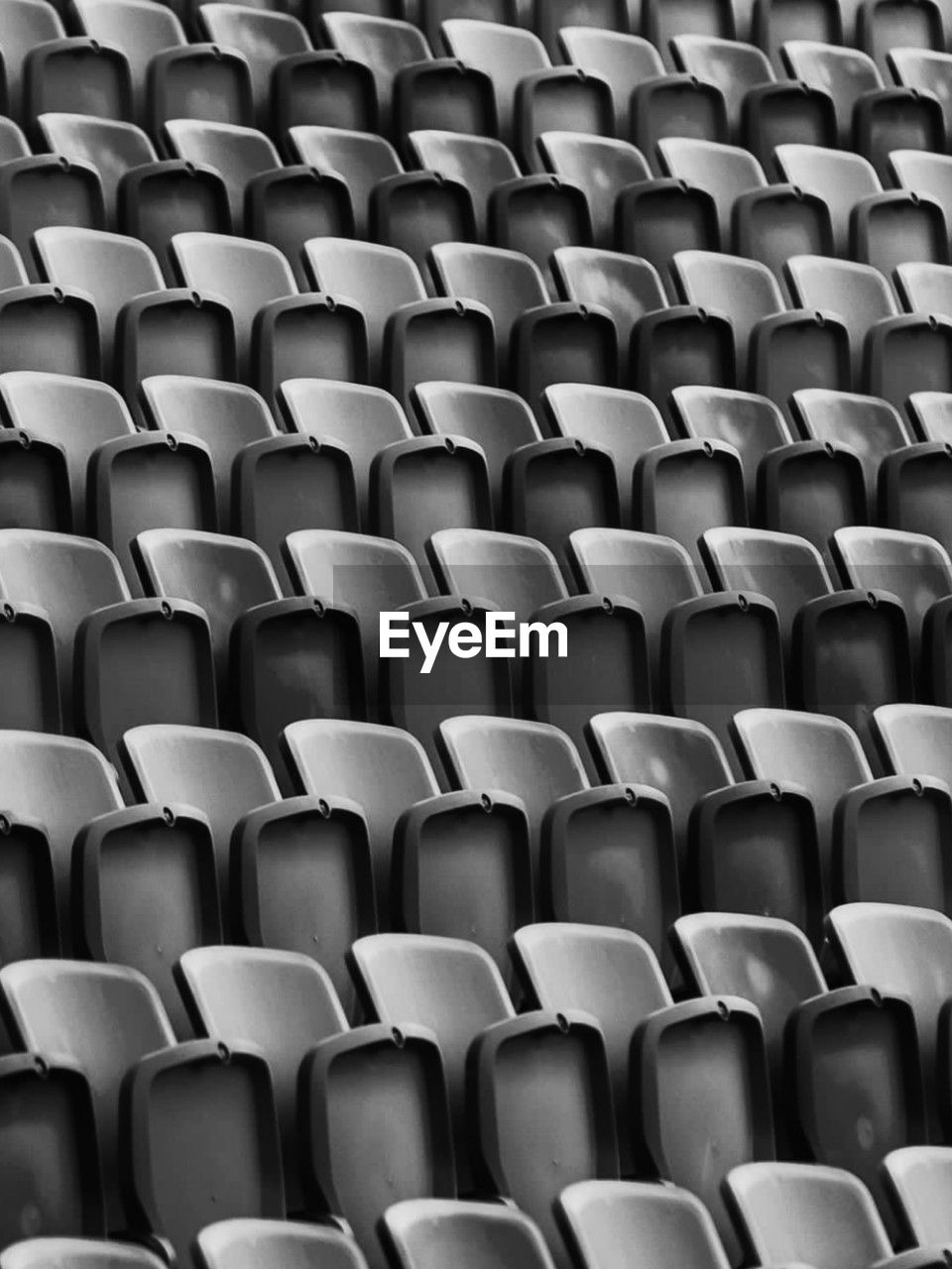 full frame shot of empty chairs at stadium