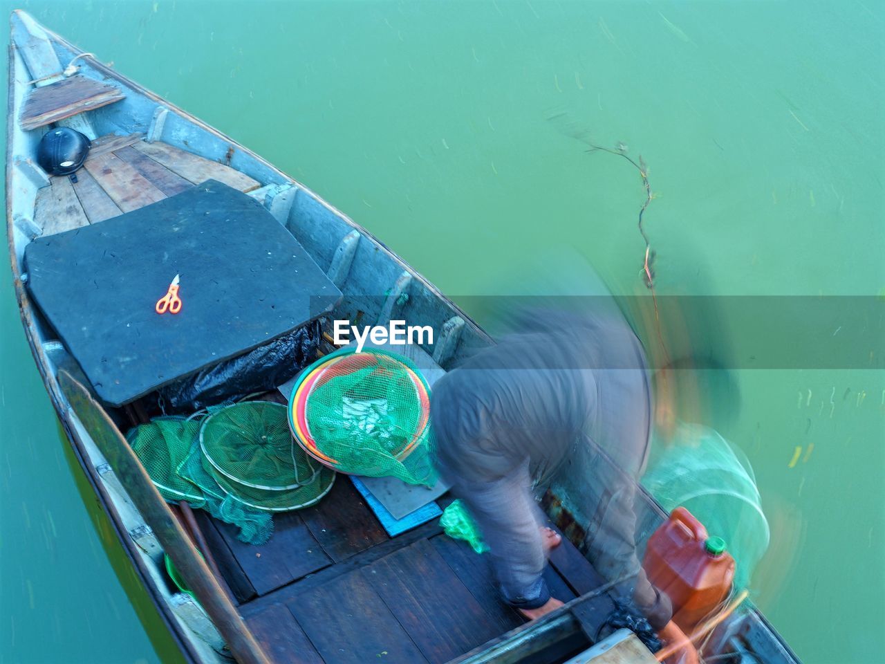 High angle view of man in fishing boat on sea