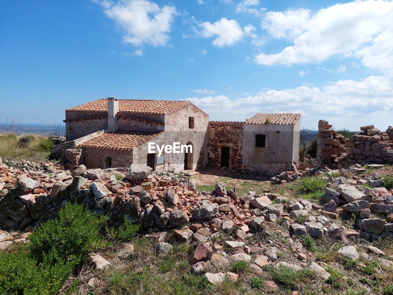 ruins, architecture, built structure, sky, history, building exterior, building, the past, nature, ancient history, cloud, old ruin, house, fortification, village, land, no people, landscape, ancient, rock, old, abandoned, ruined, travel destinations, stone material, residential district, outdoors, plant, blue, day, wall, travel, rundown, rural area, damaged, vacation, environment, scenics - nature