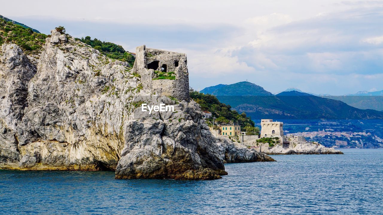 Building by sea against sky