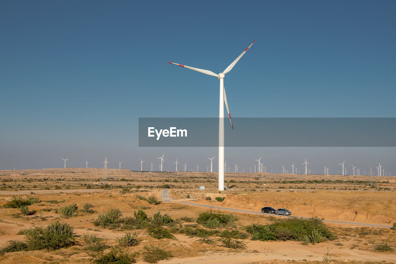 WINDMILL ON FIELD AGAINST SKY