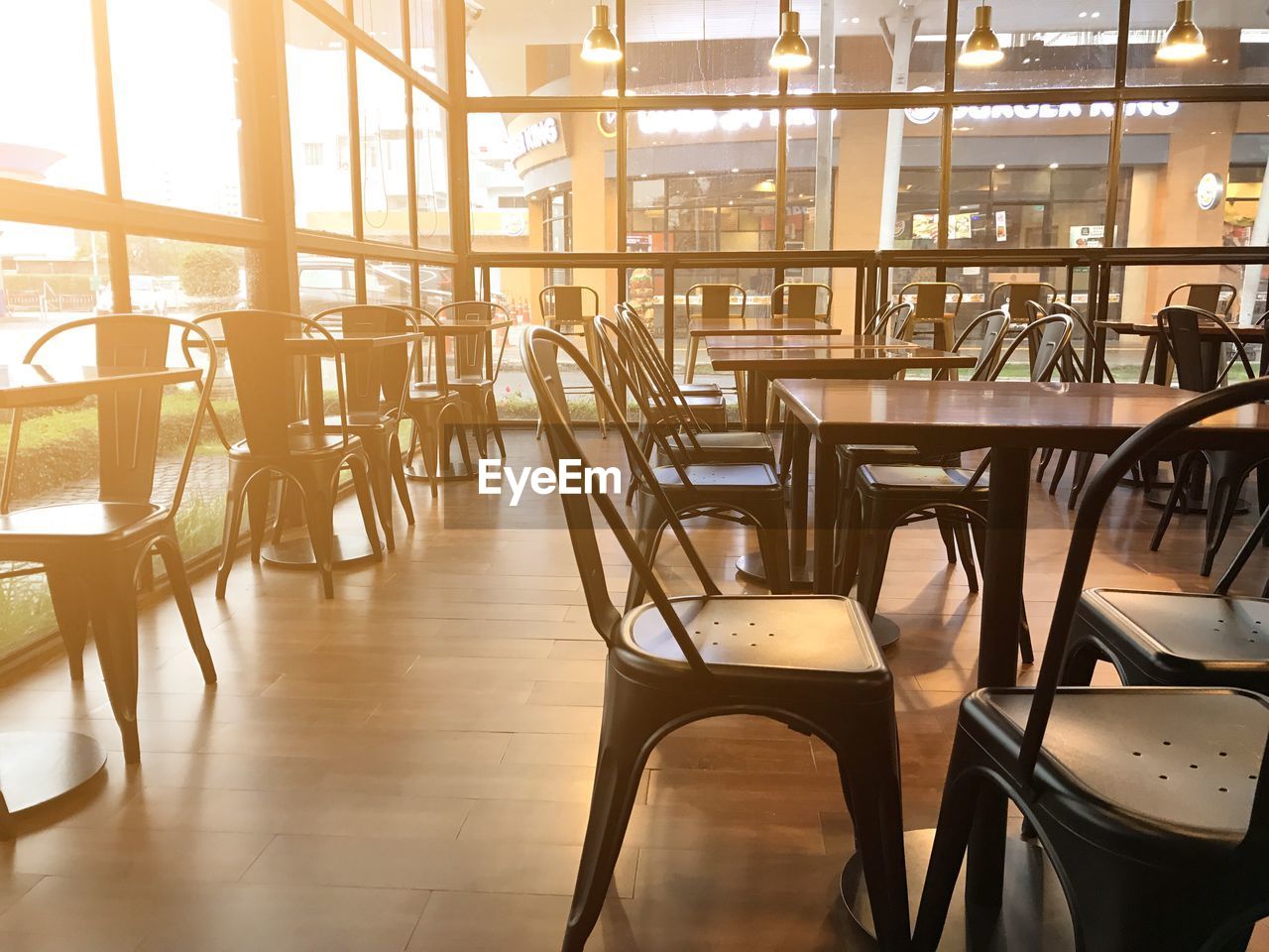 Empty chairs and tables in restaurant