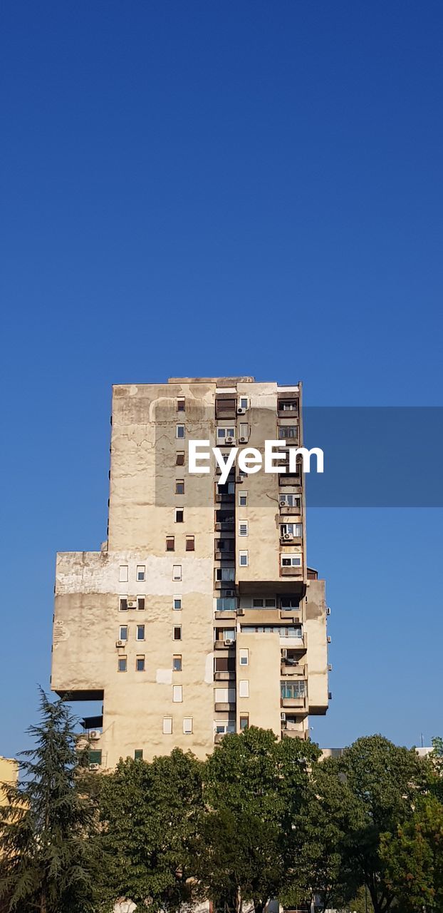 Low angle view of building against clear blue sky