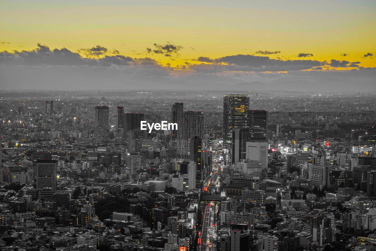 high angle view of illuminated buildings against sky during sunset