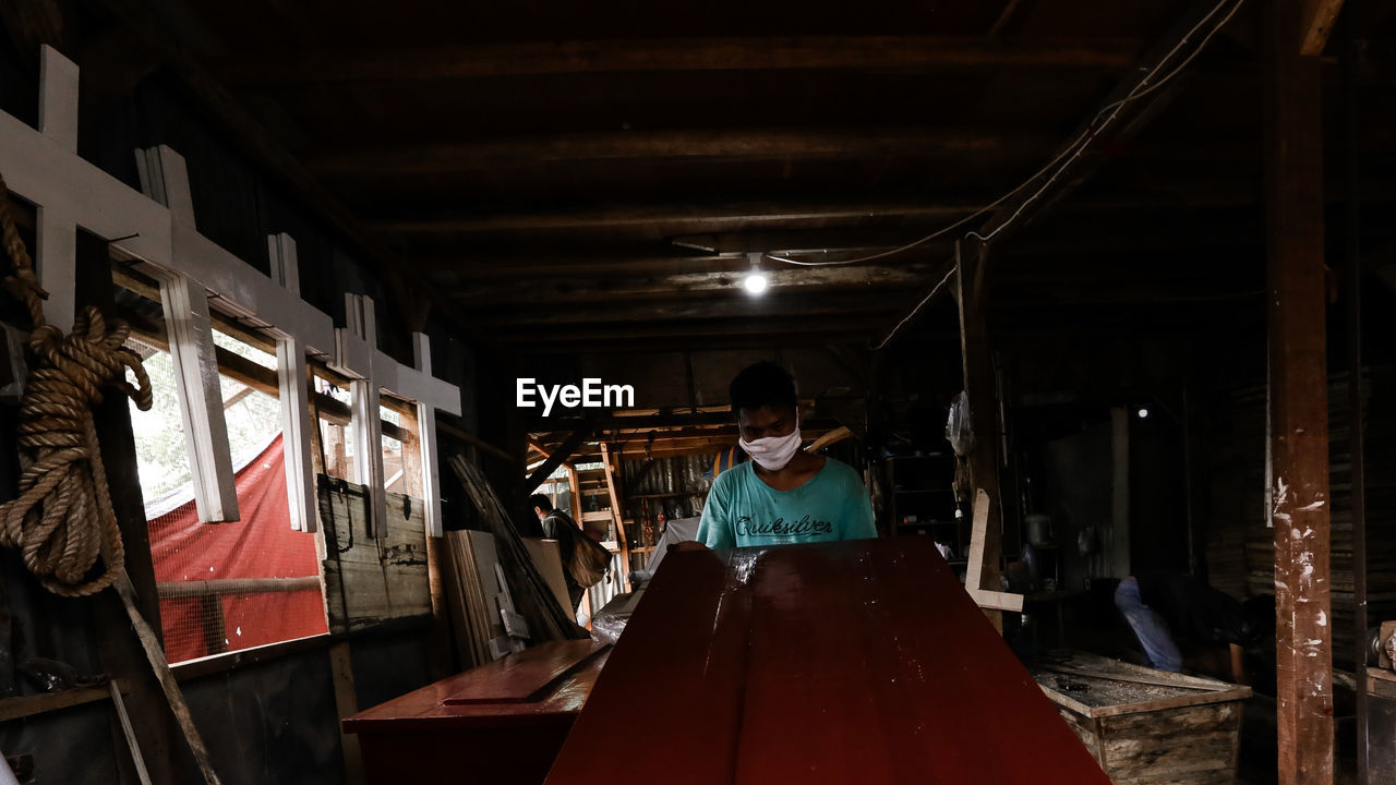 Workers at a small and medium-sized business producing coffins and crosses in jakarta