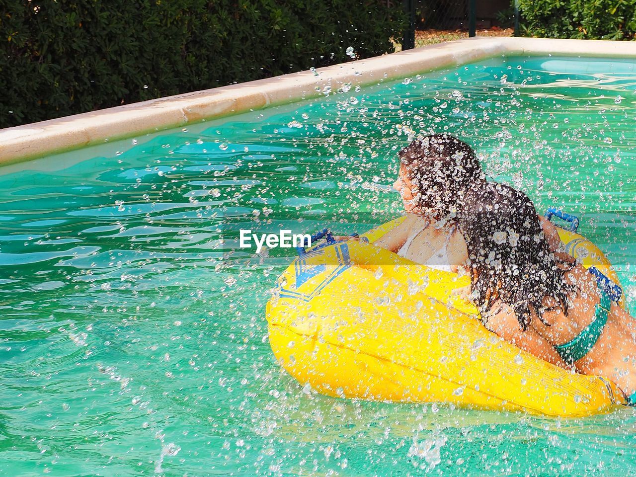 Full length of boy in water at swimming pool