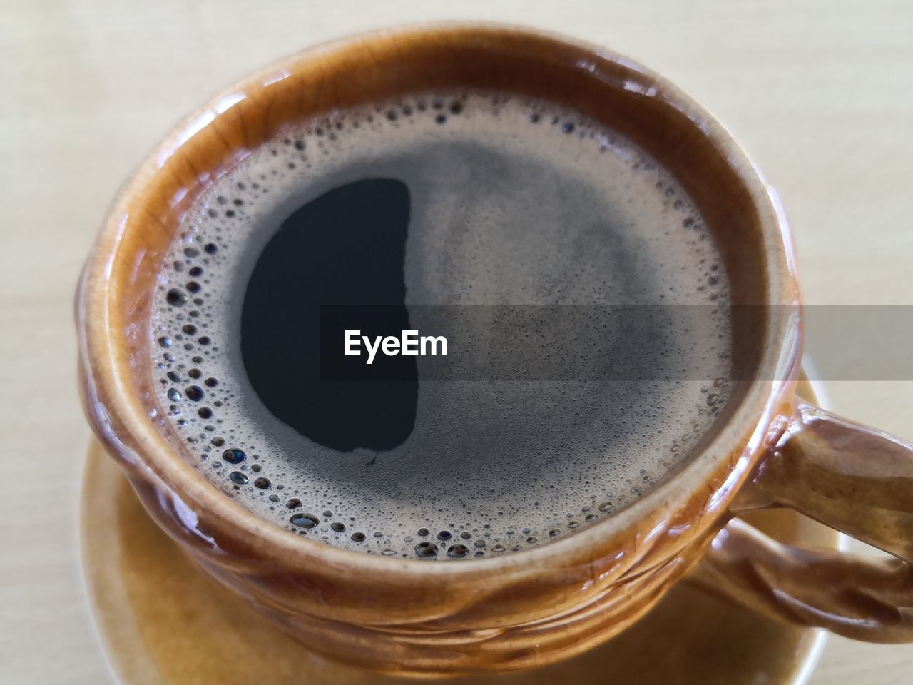 CLOSE-UP OF COFFEE CUP ON TABLE