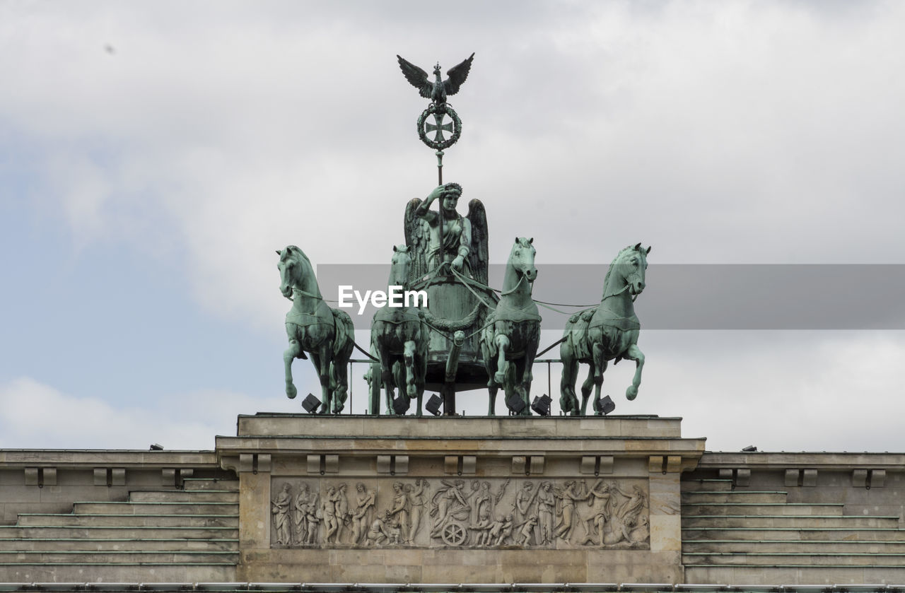 Low angle view of statue against cloudy sky