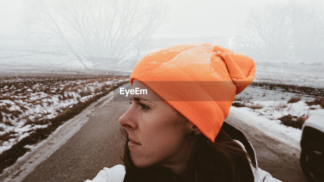 Portrait of mid adult woman looking away during winter