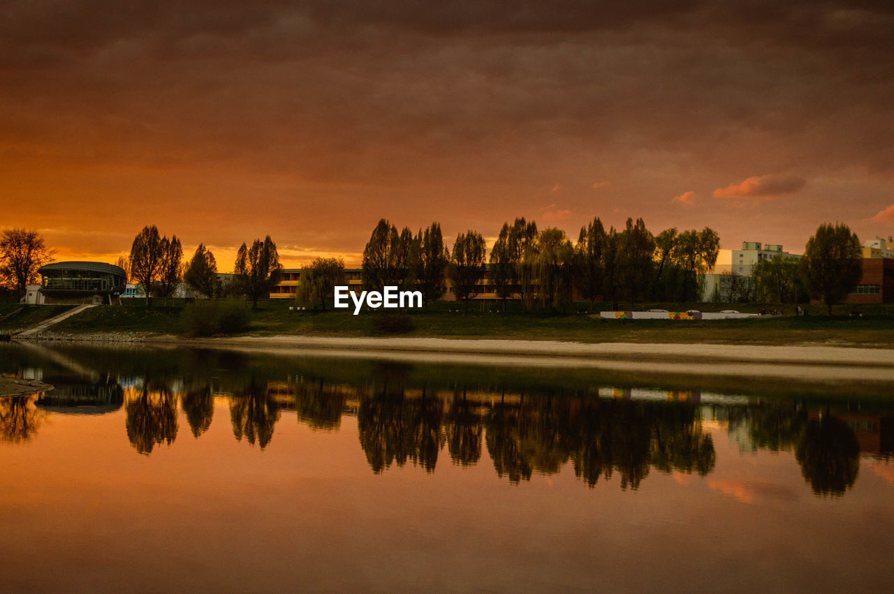 Scenic view of calm lake at sunset