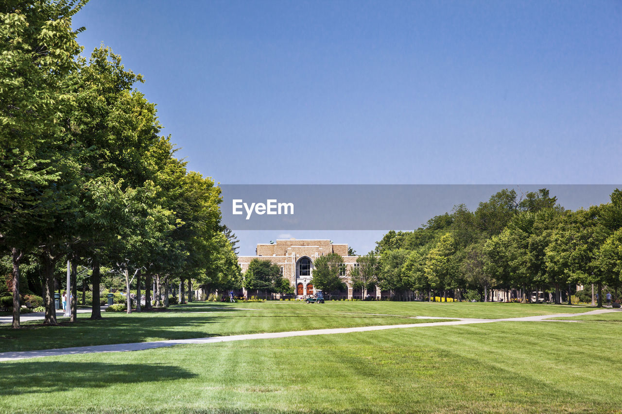 Lawn in university of notre dame against clear sky