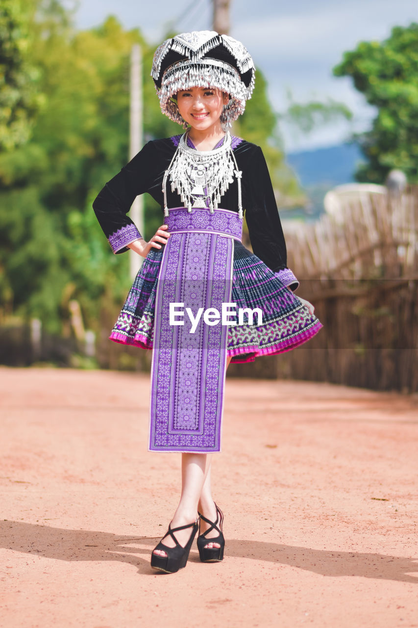 PORTRAIT OF A SMILING GIRL ON PURPLE