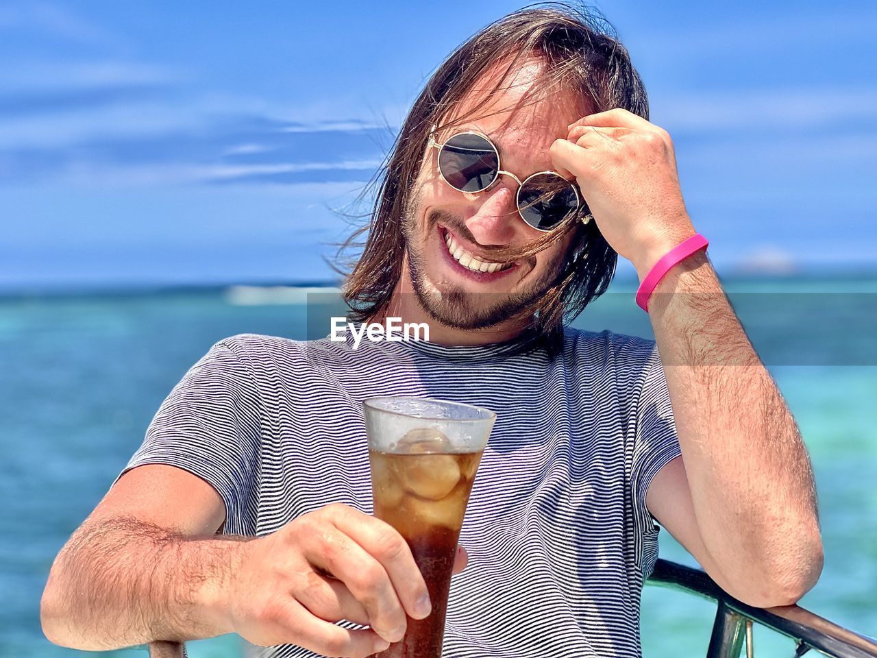 Portrait of smiling man holding drink glass