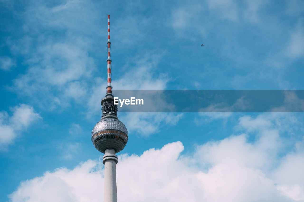 Low angle view of television tower - berlin against cloudy sky