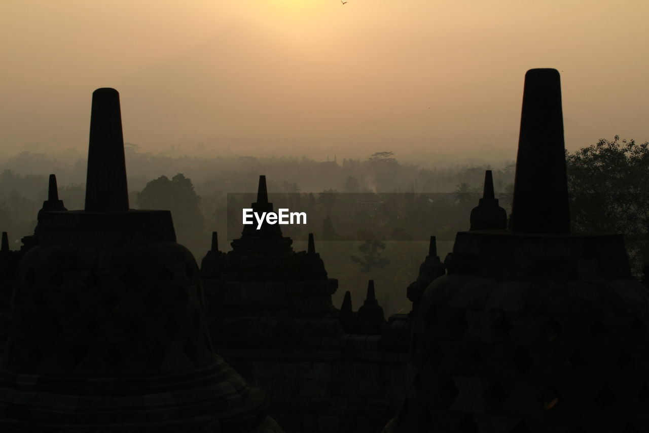 Silhouette of temple building at sunrise