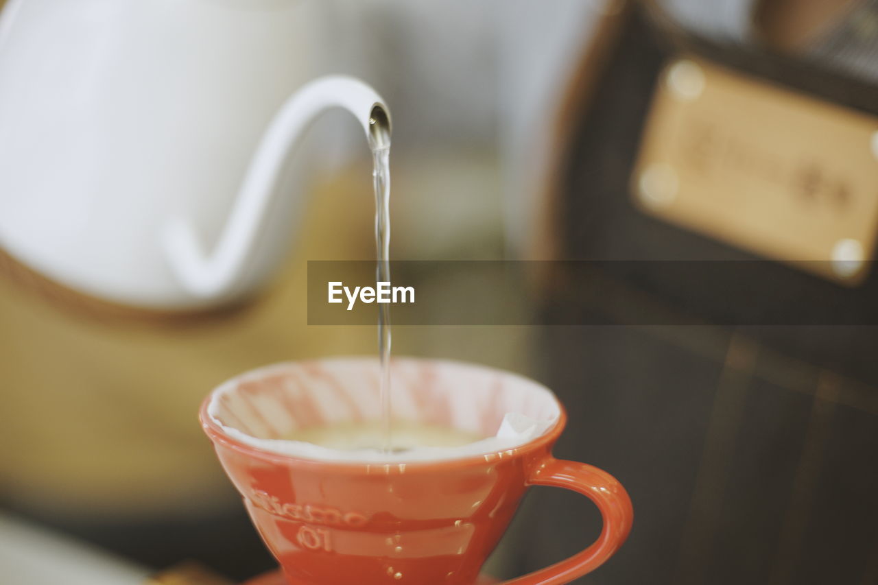 CLOSE-UP OF COFFEE CUP ON GLASS