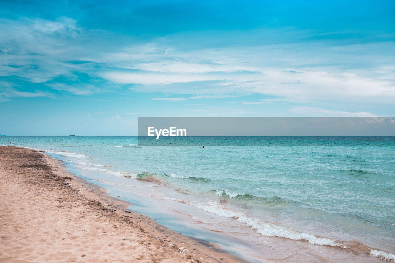 SCENIC VIEW OF BEACH AGAINST BLUE SKY