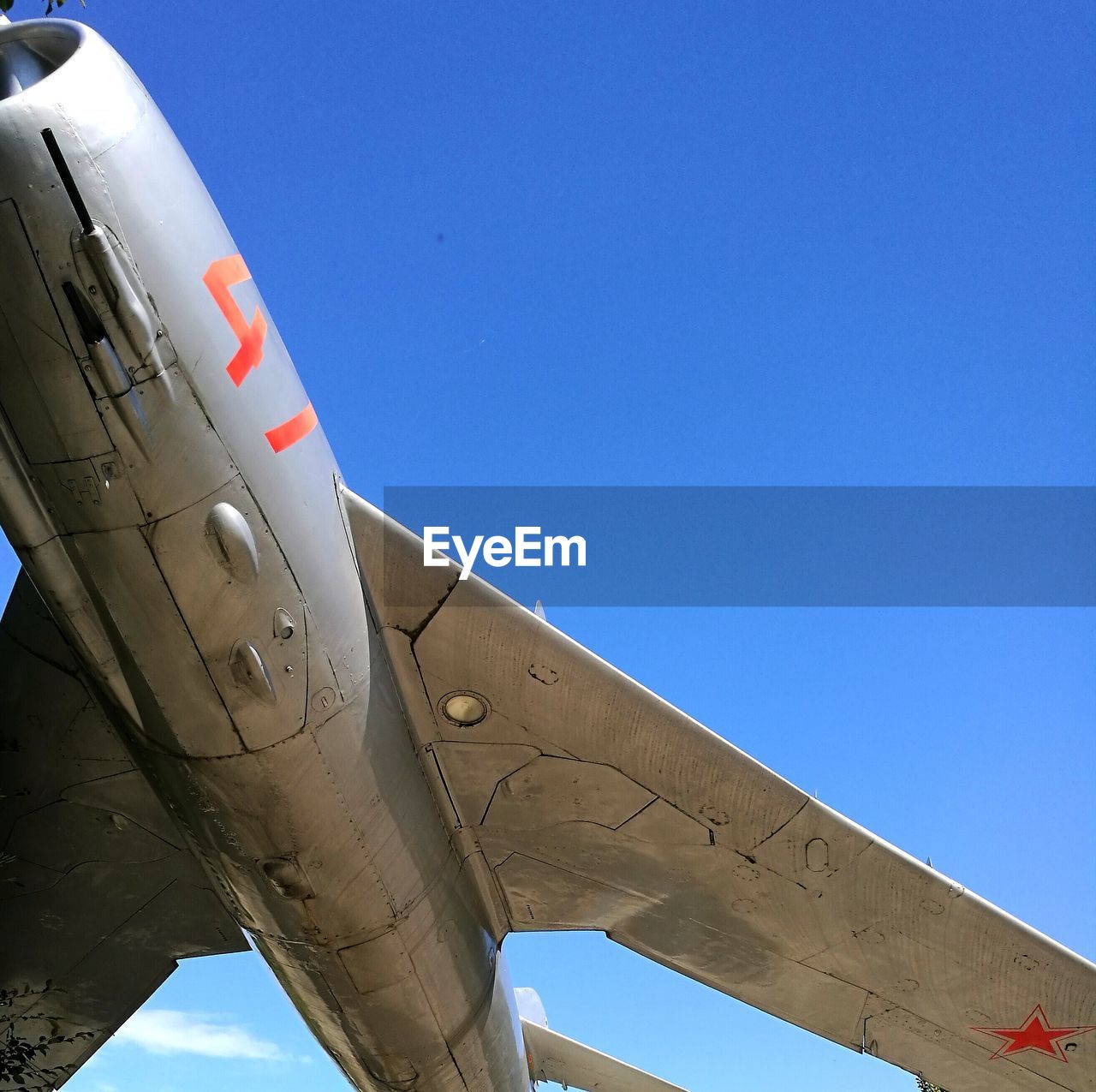 AIRPLANE WING AGAINST BLUE SKY