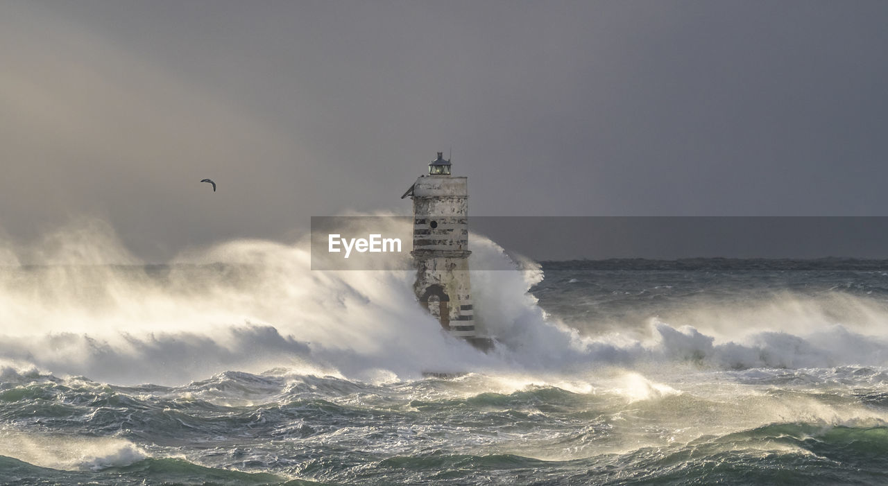 SCENIC VIEW OF SEA AGAINST BUILDINGS