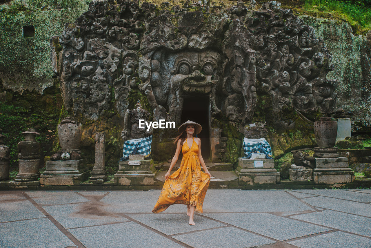 Full length of woman walking at goa gajah