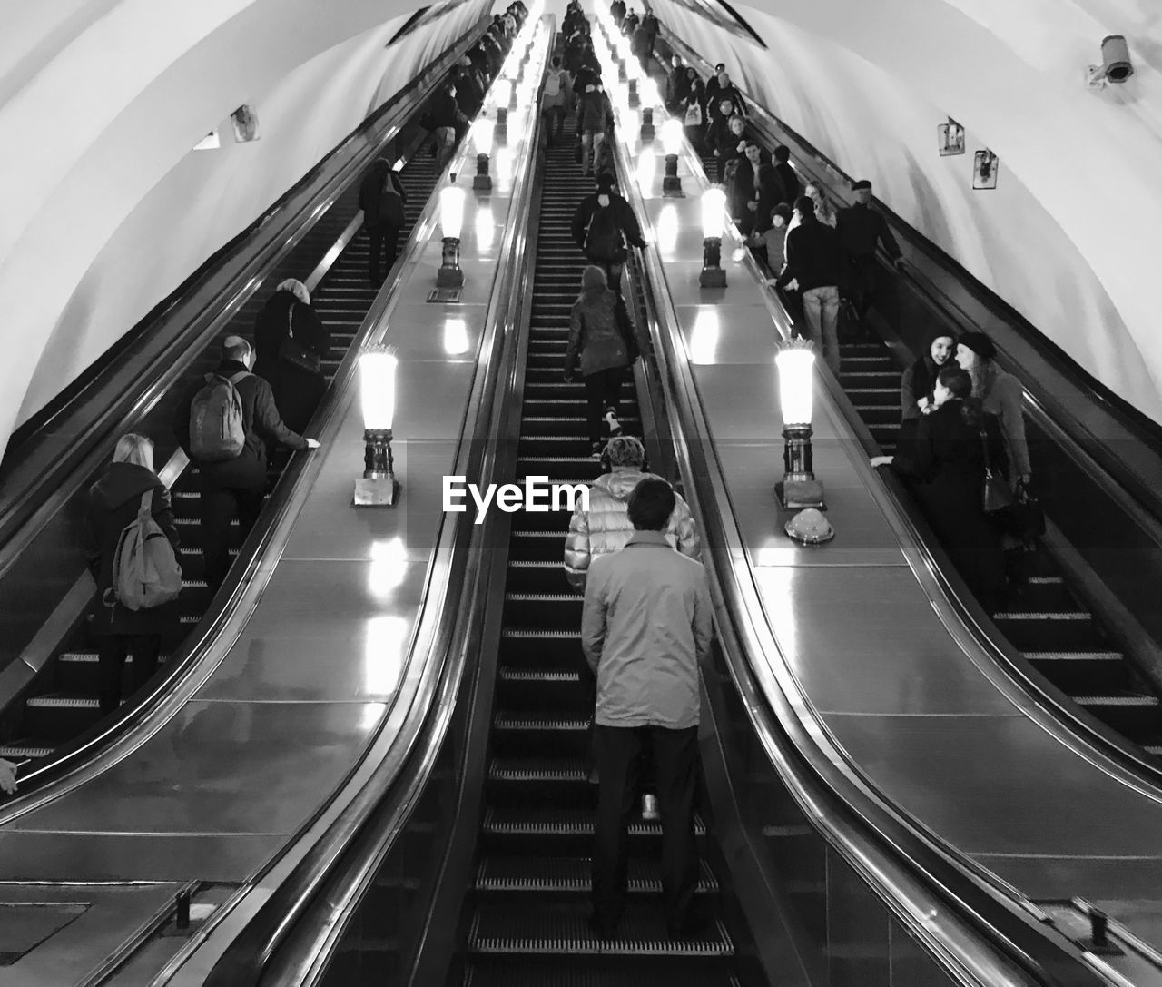 People standing on escalator at subway station