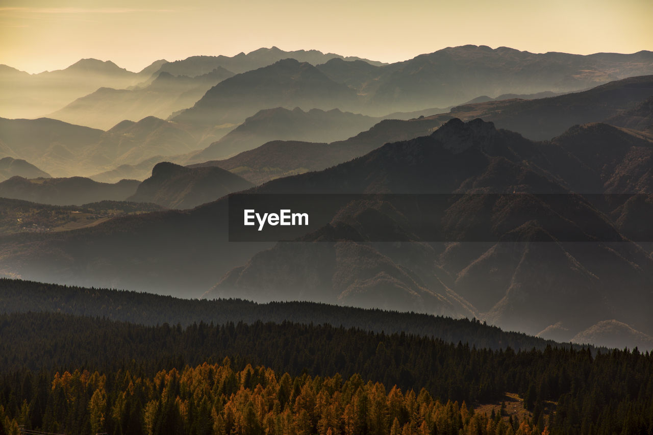 Scenic view of mountains against sky at sunset