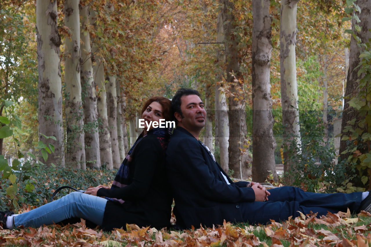 Portrait of couple sitting at park