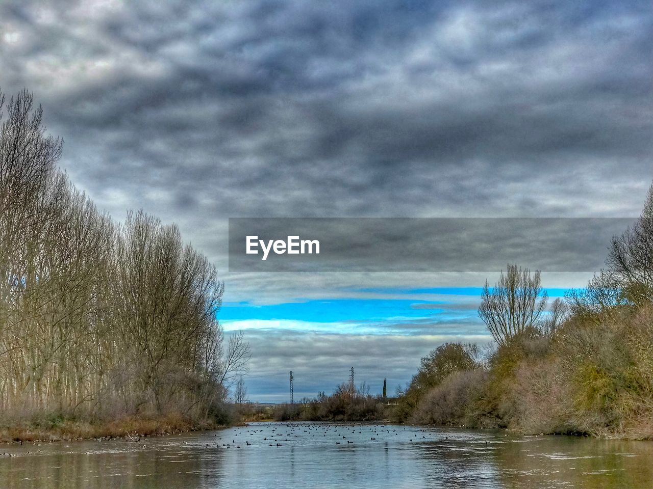 VIEW OF LAKE AGAINST CLOUDY SKY