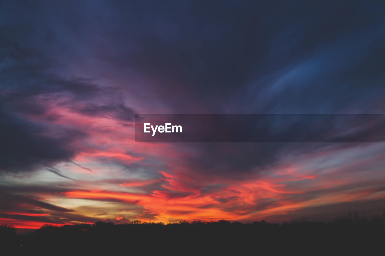 Low angle view of dramatic sky during sunset