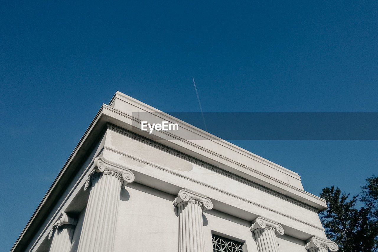 Low angle view of building against clear blue sky