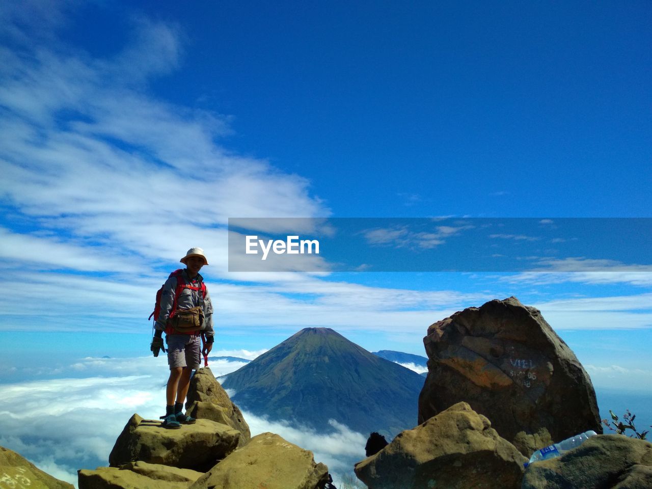 Man on snowcapped mountain against sky